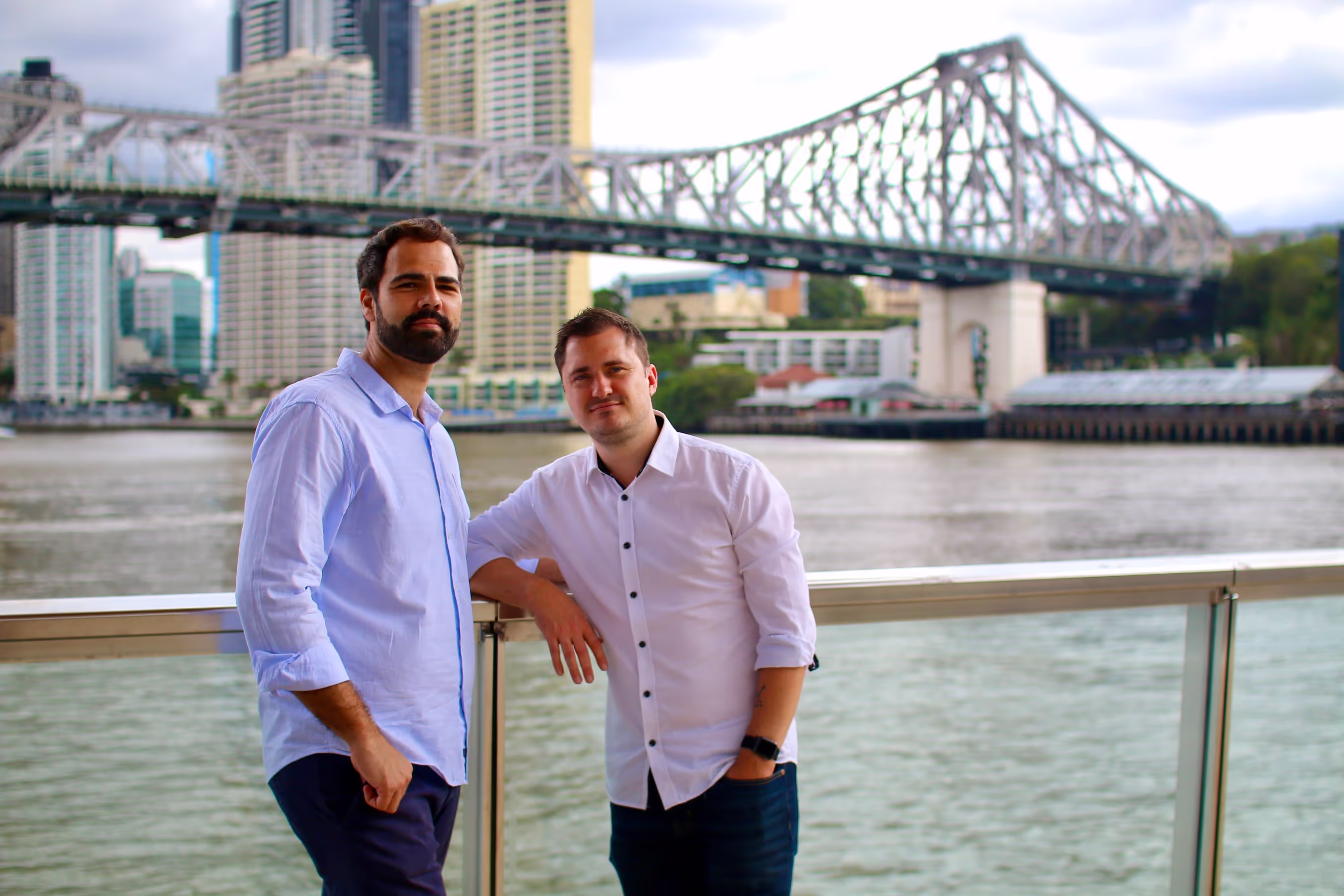 Photo of the founders posing in front of a bridge in Brisbane